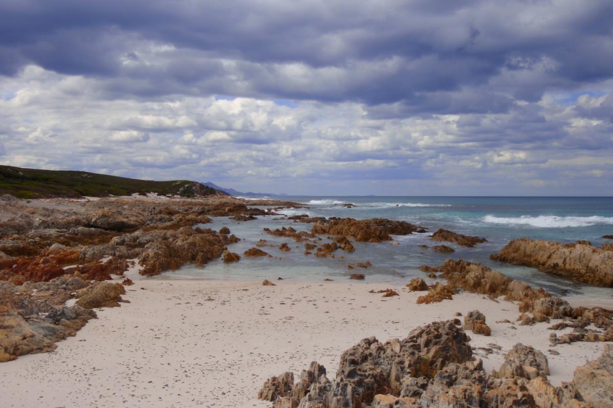 Rocky beach leading down to the water. 